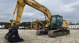 Kobelco excavator on construction site, heavy machinery for earthmoving and demolition, emphasizing advanced construction equipment from Upper Echelon Technology Group.