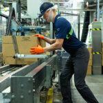 High-tech packaging machinery in a modern industrial warehouse focusing on automation and manufacturing solutions.