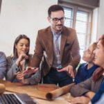 Professional business team meeting discussing technology solutions at Upper Echelon Technology Group. Collaborative IT strategies, innovation, and tech support.